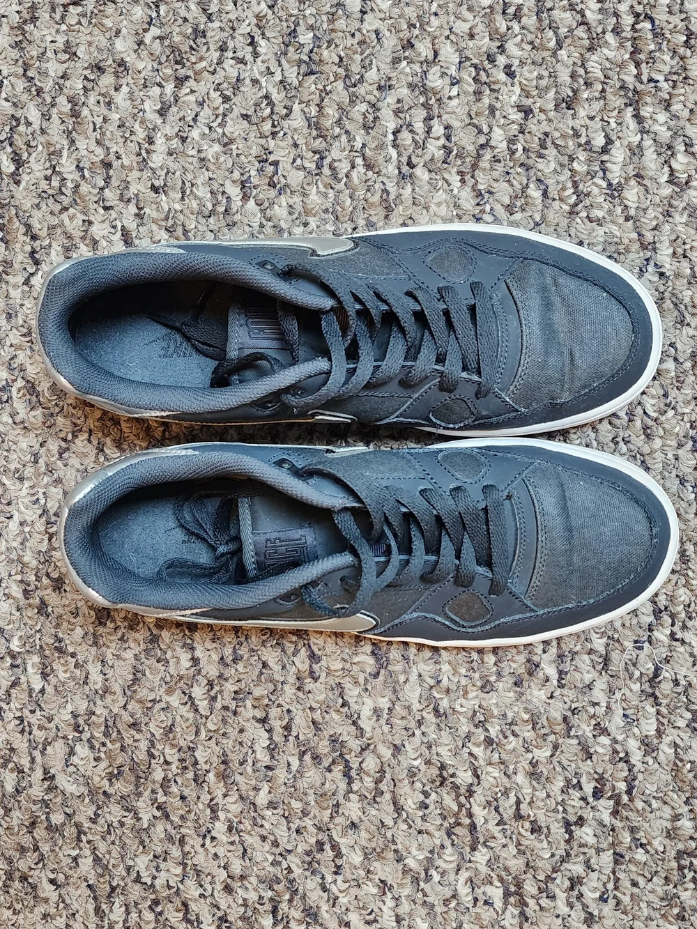 Nike Black Sneakers with Metallic Silver Swoosh and White Sole